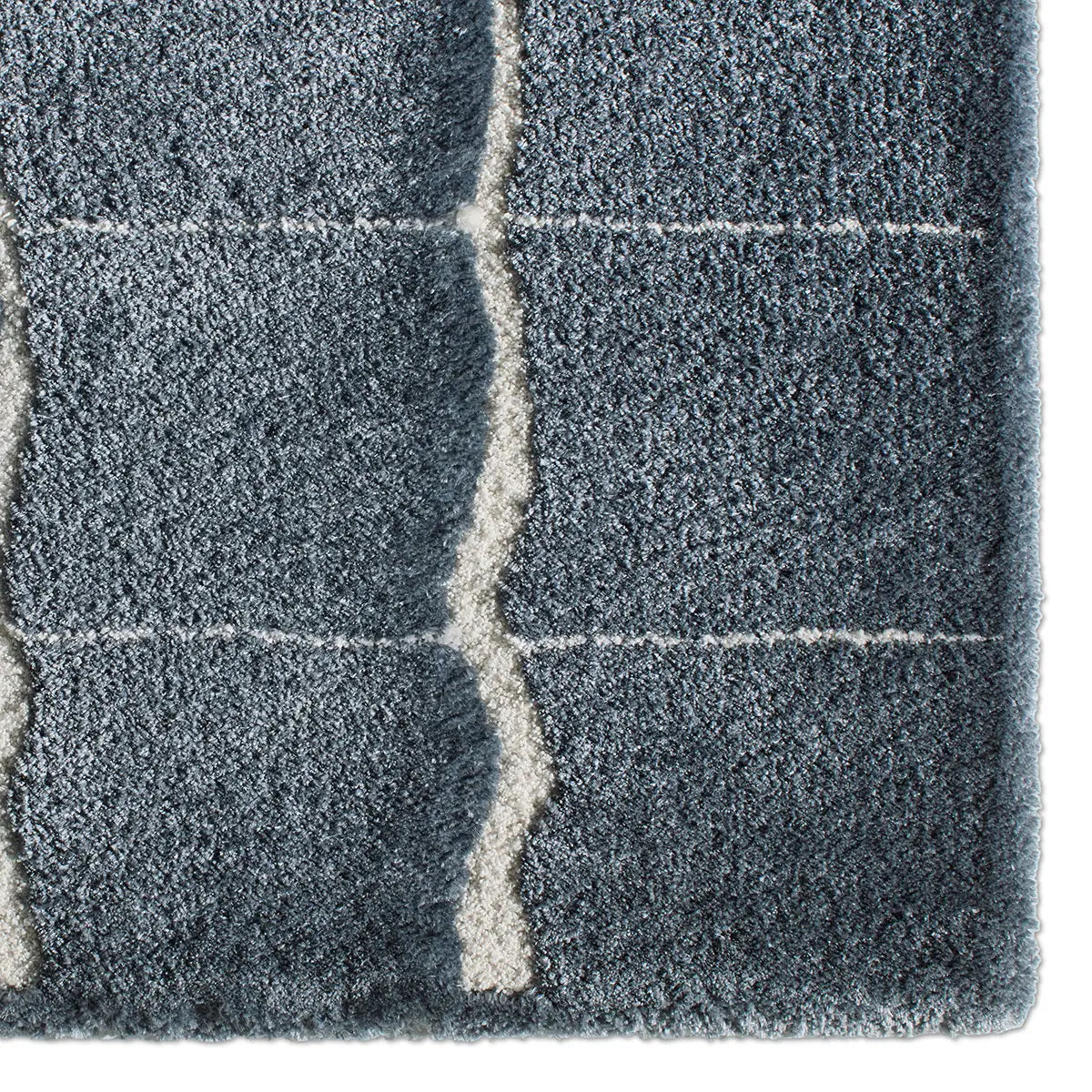 Close-up of a textured blue rug with a checkered pattern