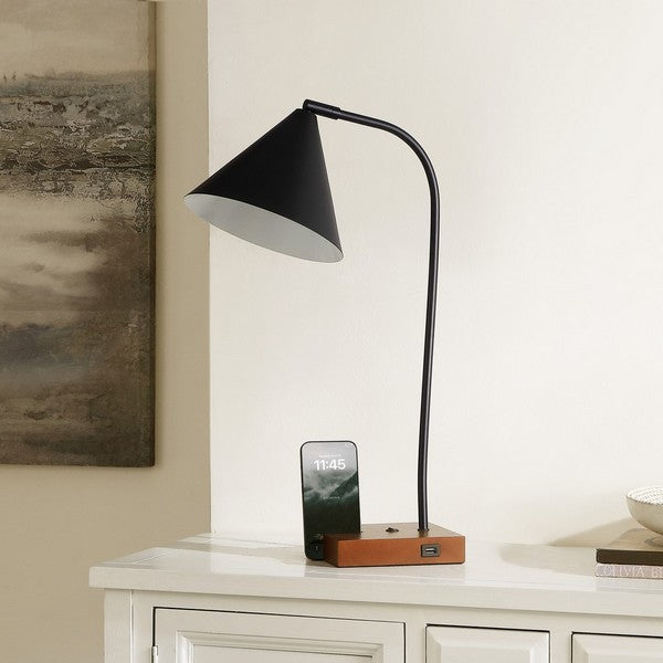 Black table lamp with wooden base on a white surface next to a smartphone displaying time.