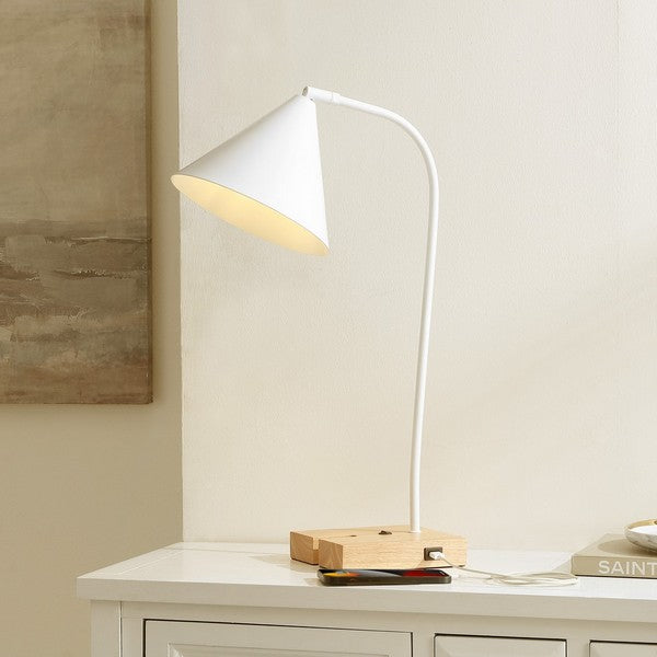 Modern desk lamp on a white surface with a neutral wall background