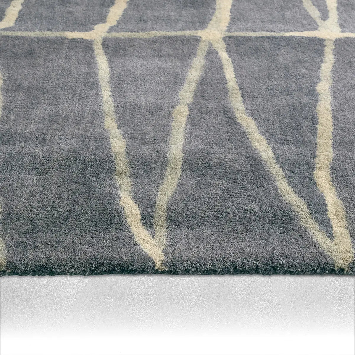 Gray rug with beige abstract patterns on a white background