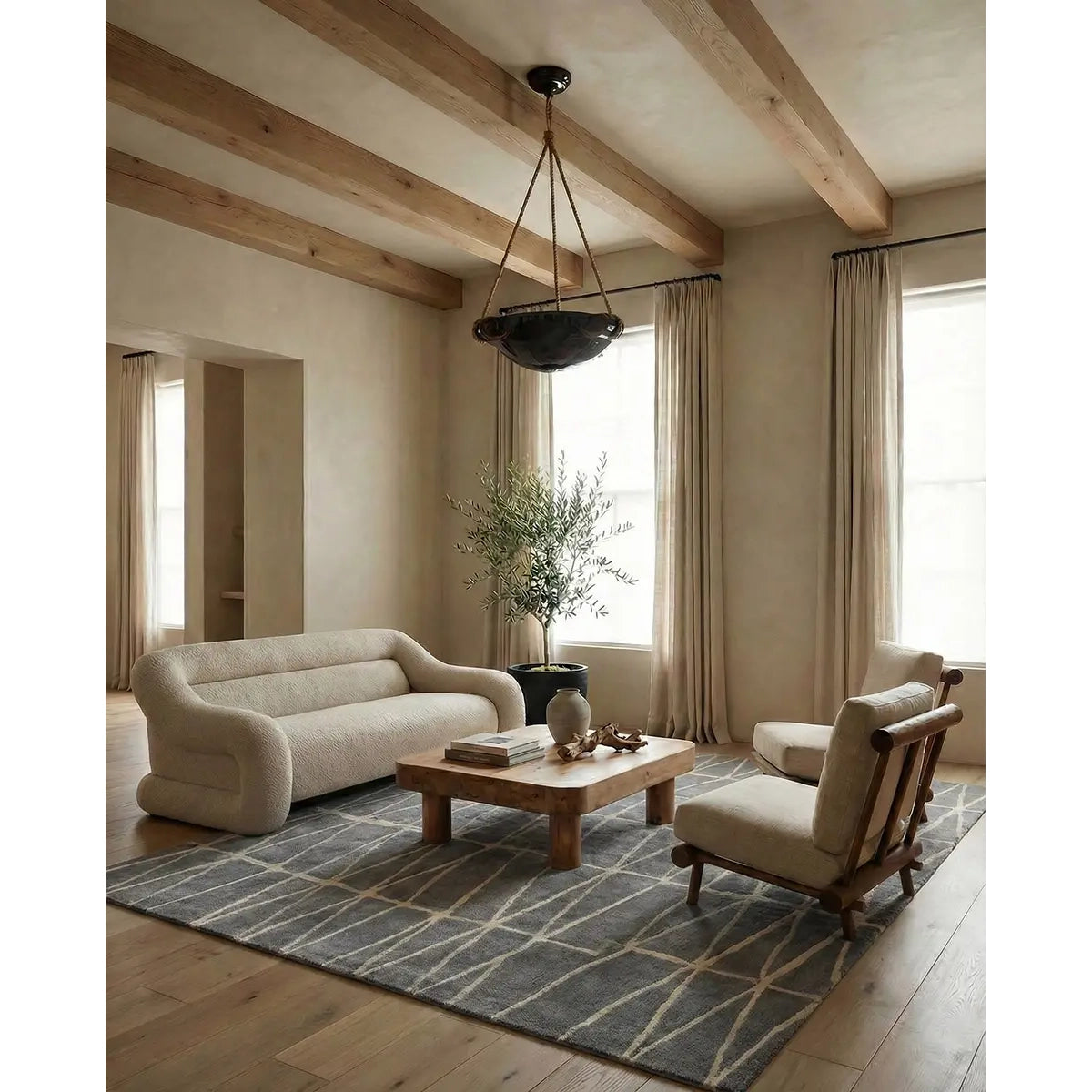 Modern living room with beige sofa, armchair, and wooden coffee table.