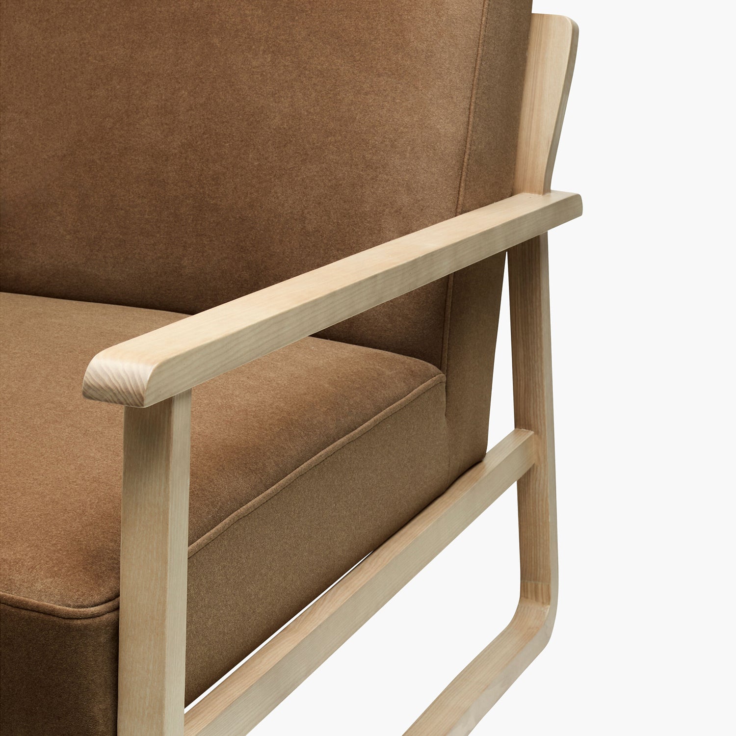 Brown upholstered chair with wooden armrests on a white background