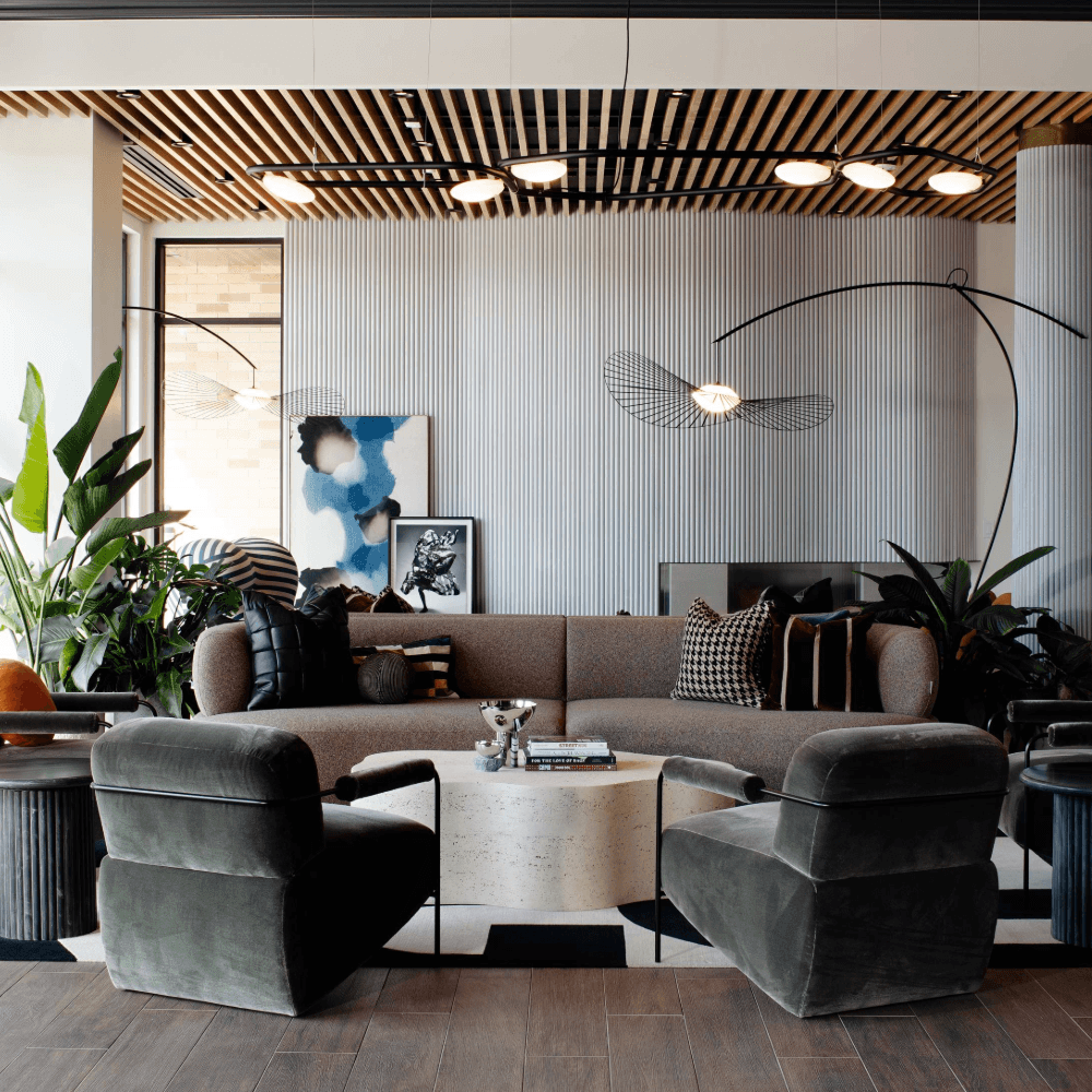 Modern dining area with a round table and chairs, and a living room with furniture and decor.