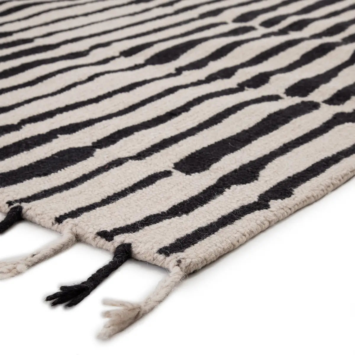 Beige rug with black abstract pattern on a white background