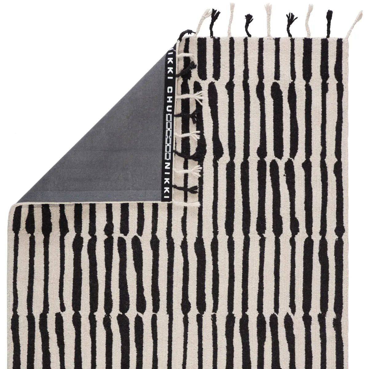 Black and white patterned towel with fringes on a white background