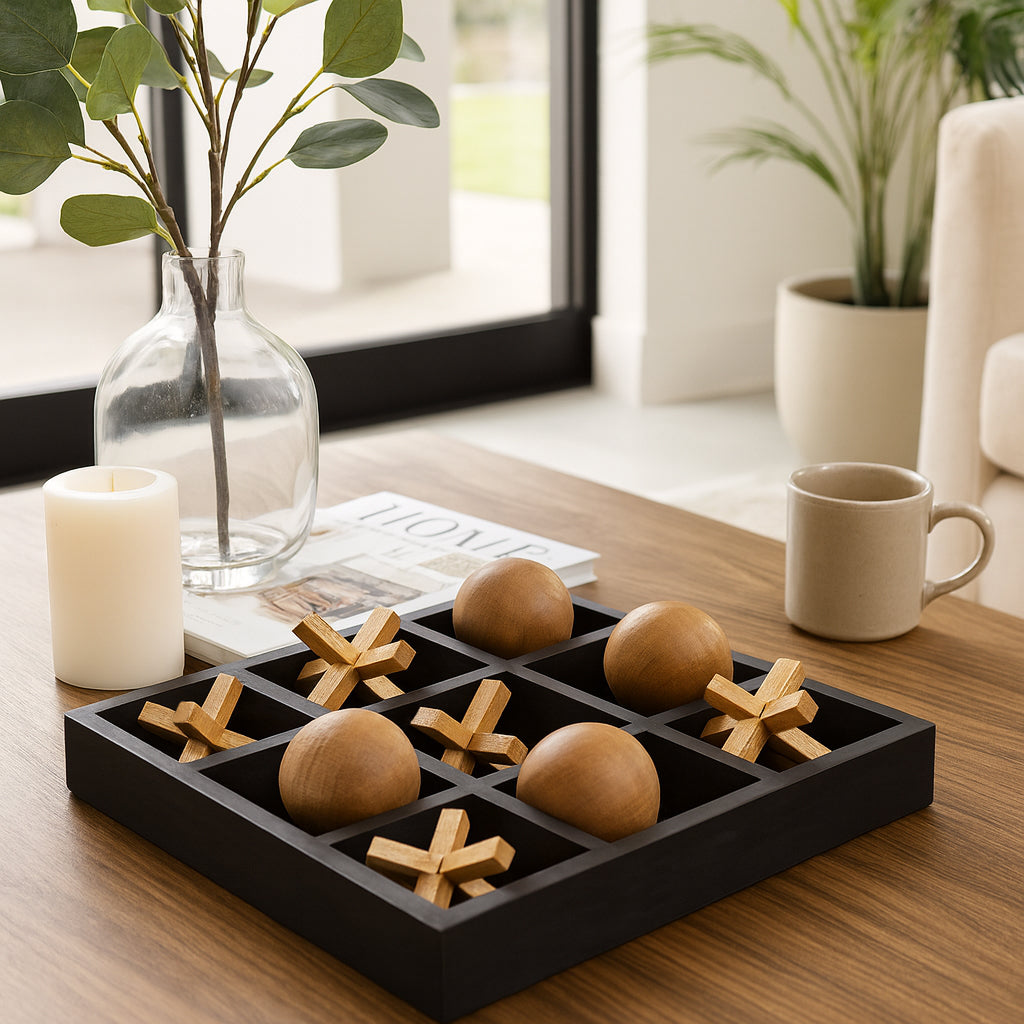 Tabletop game with wooden balls and crosses on a table with a candle and plant in the background