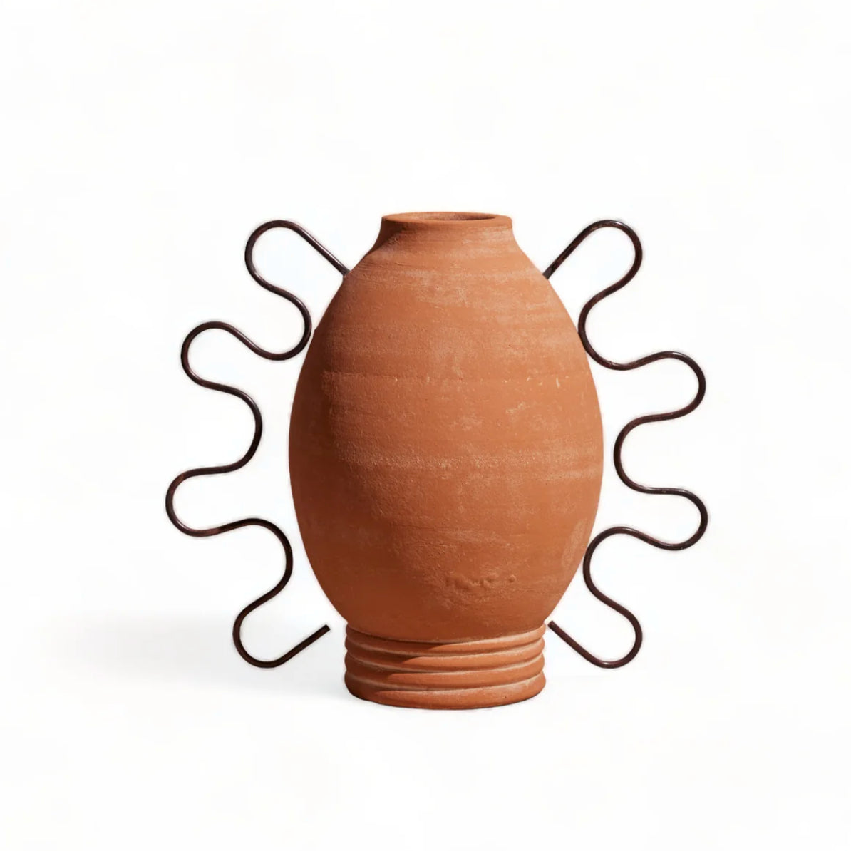 Terracotta vase on a decorative metal stand against a white background
