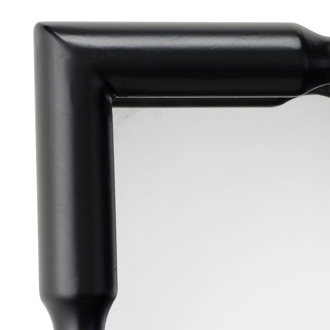 Close-up of a black frame mirror corner on a white background