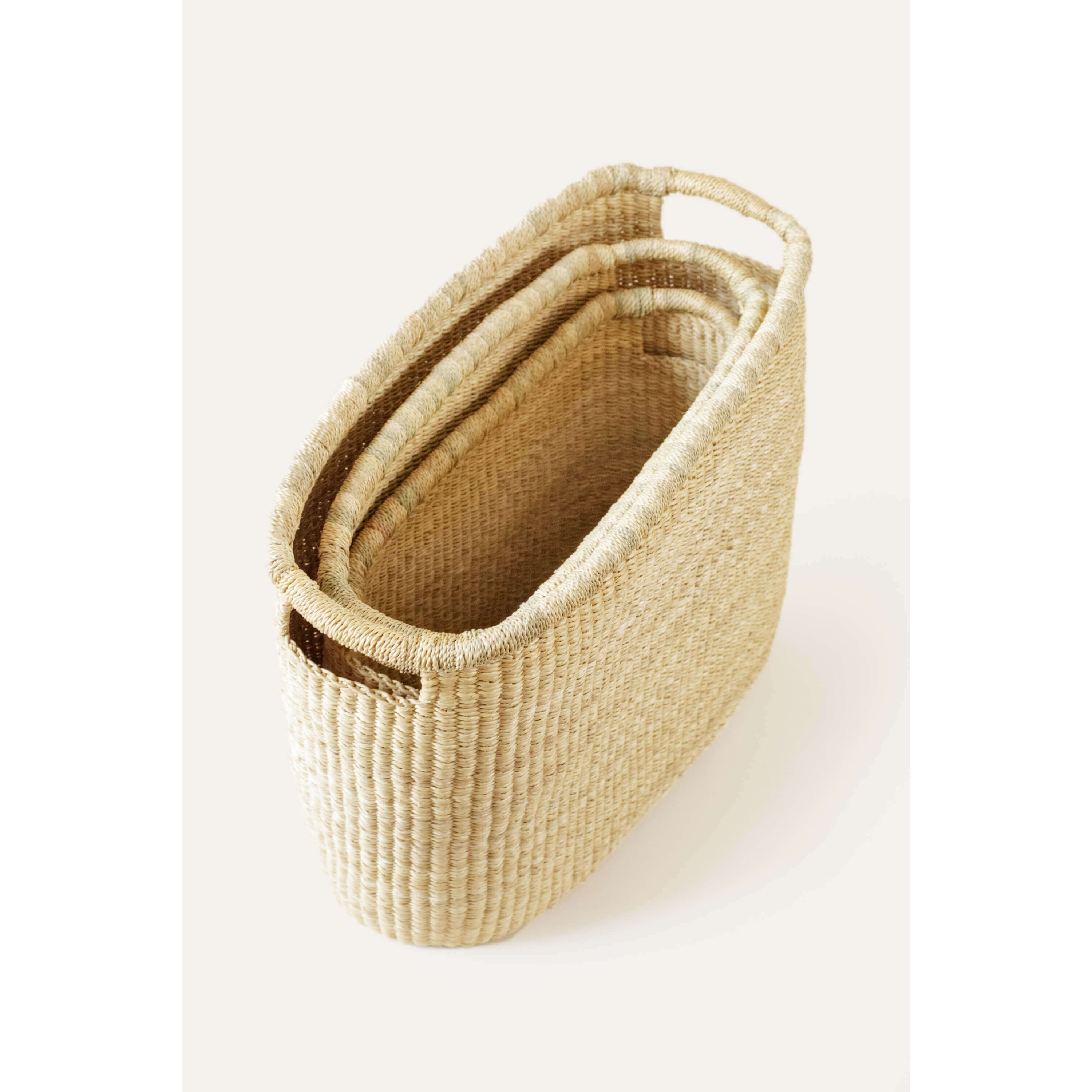 Woven basket with handles on a white background