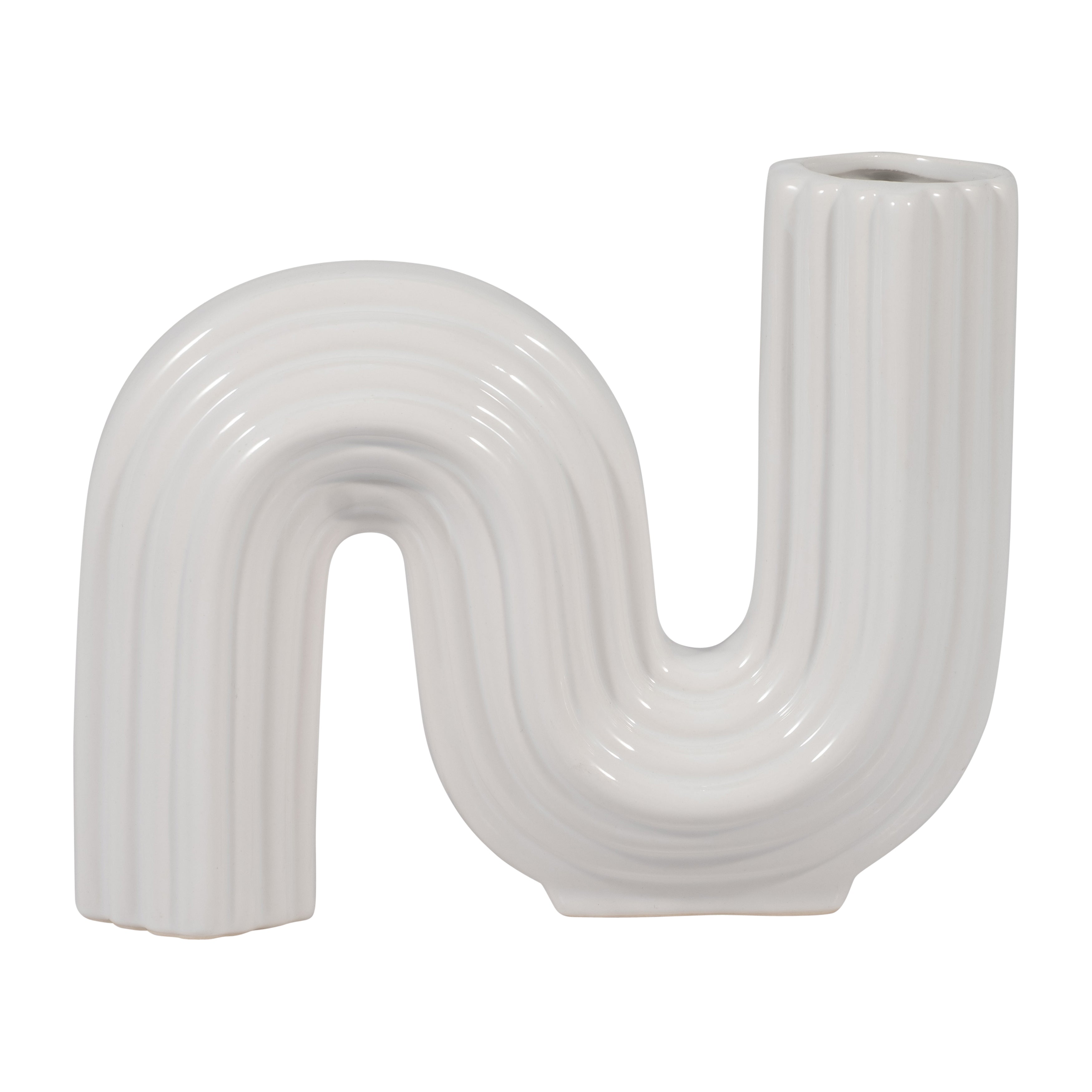 White ceramic vase shaped like a letter 'U' on a white background