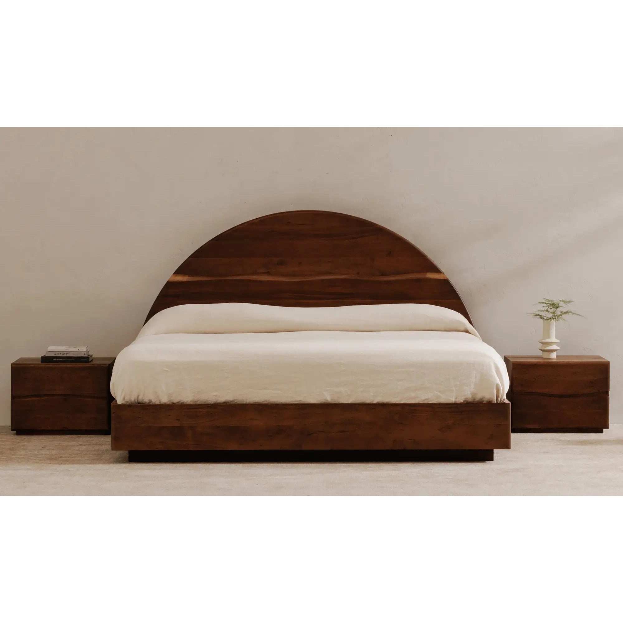 Wooden bed with white bedding in a minimalistic room.