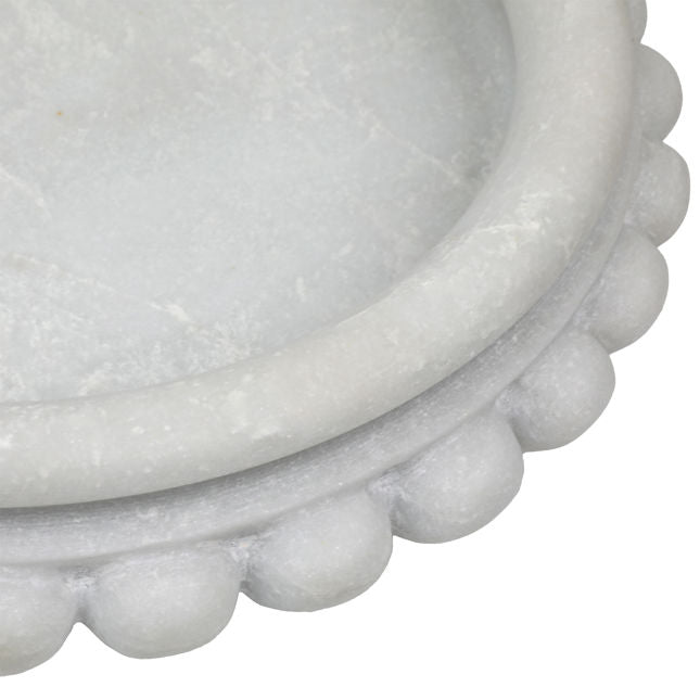 Close-up of a textured white stone bowl on a white background