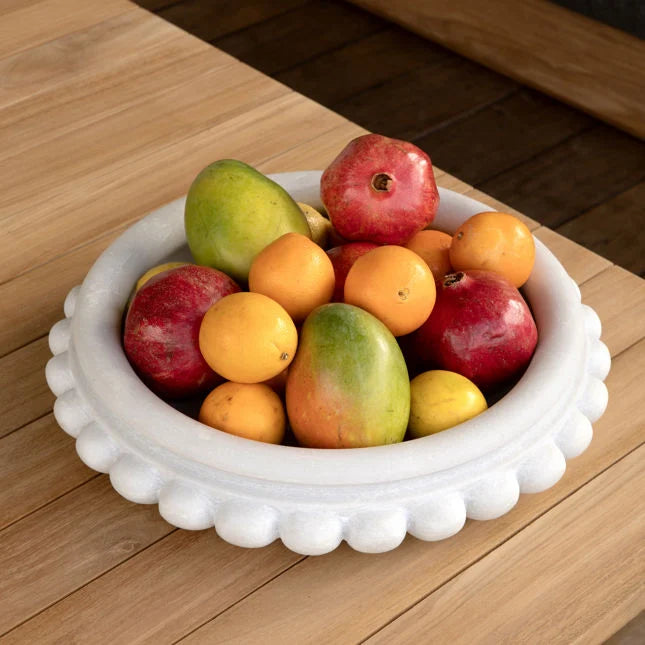 Fruit bowl with apples and oranges in a marble bowl