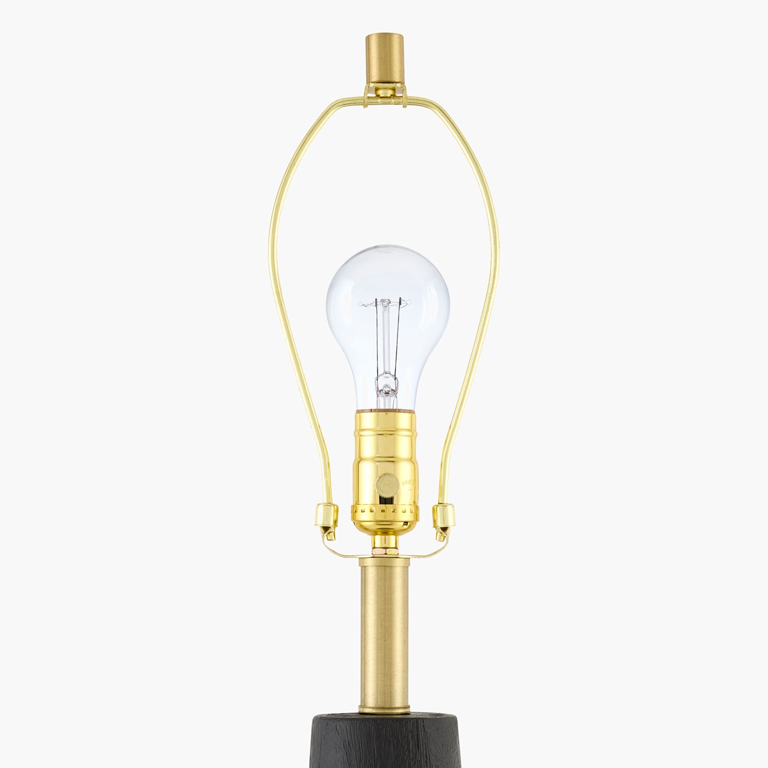 Clear light bulb with gold base on a white background
