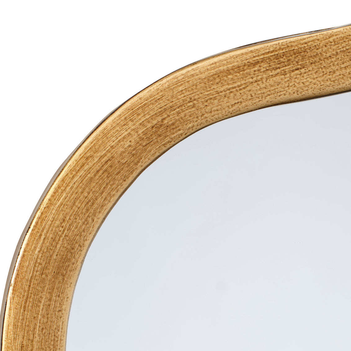 Close-up of a wavy mirror with a gold frame on a white background
