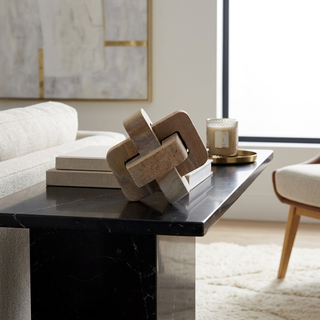 Decorative knot sculpture on a black marble table in a modern living room.