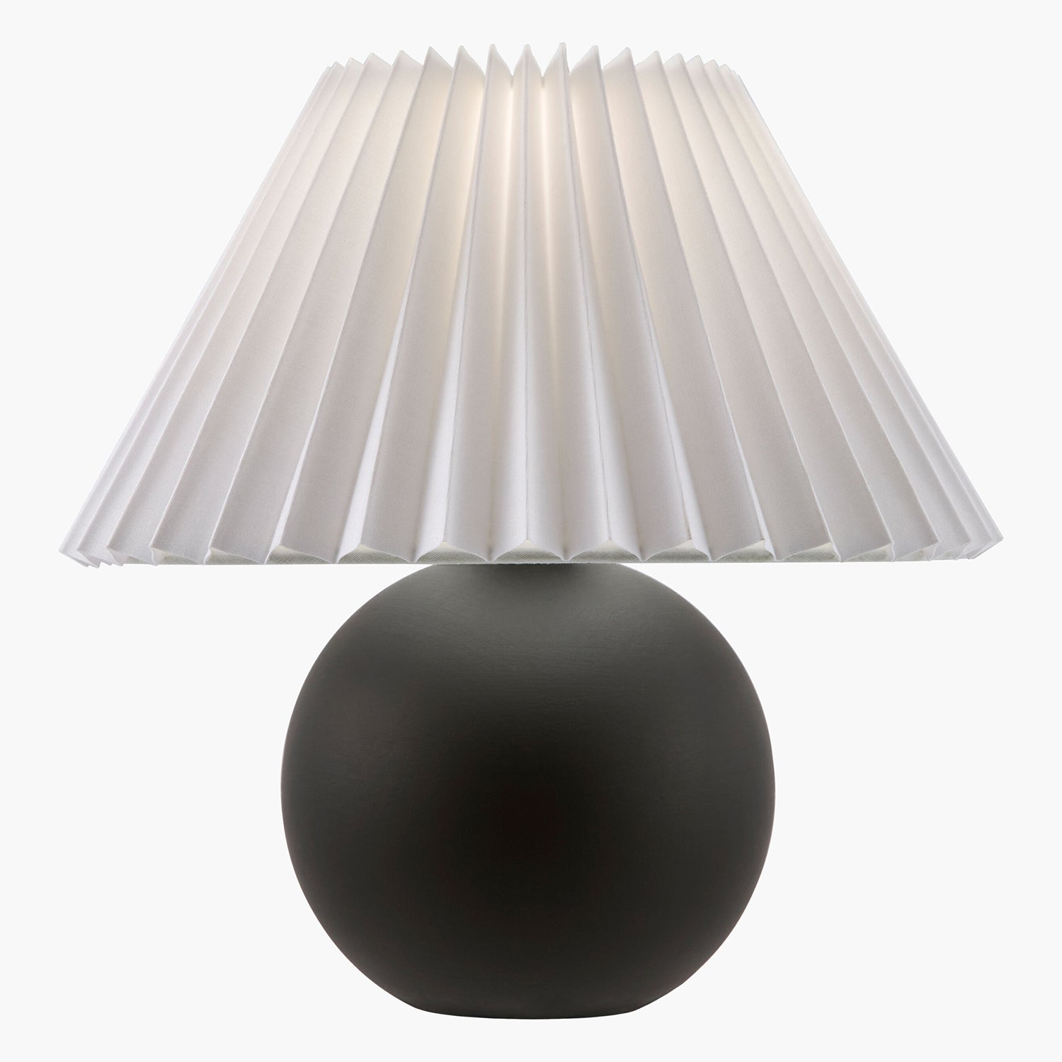Table lamp with a pleated white shade and black base on a white background