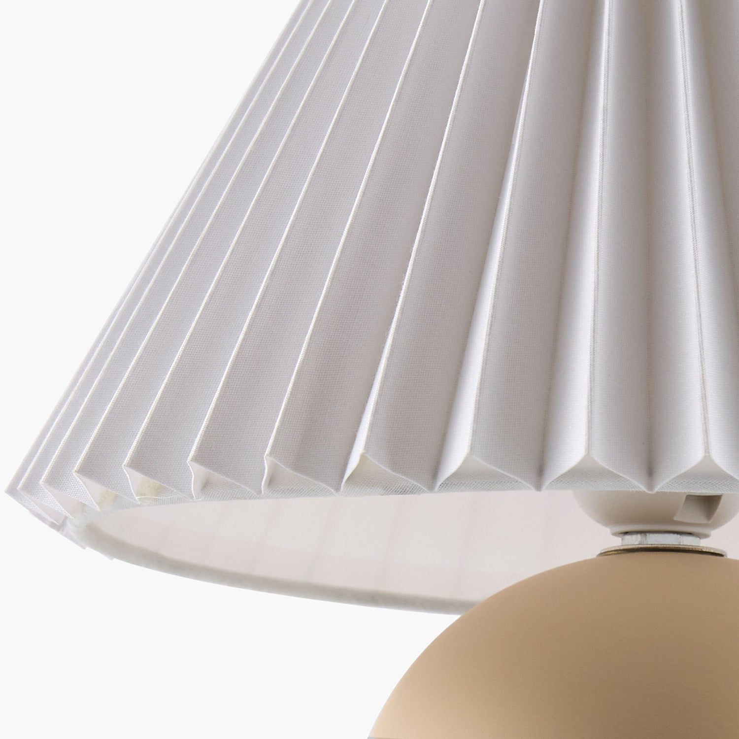 Close-up of a pleated white lampshade on a neutral background