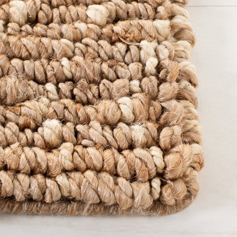 Close-up of a textured beige rug on a white background