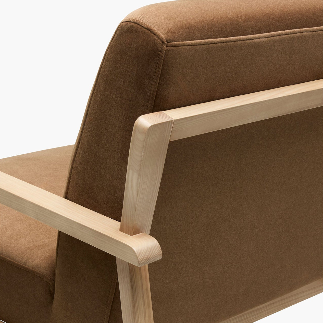 Brown upholstered chair with wooden frame on a white background