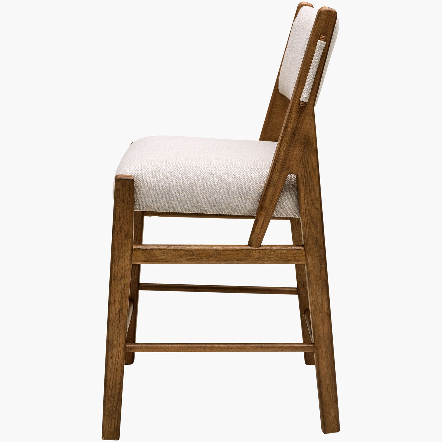 Wooden chair with white cushioned seat and backrest on a white background