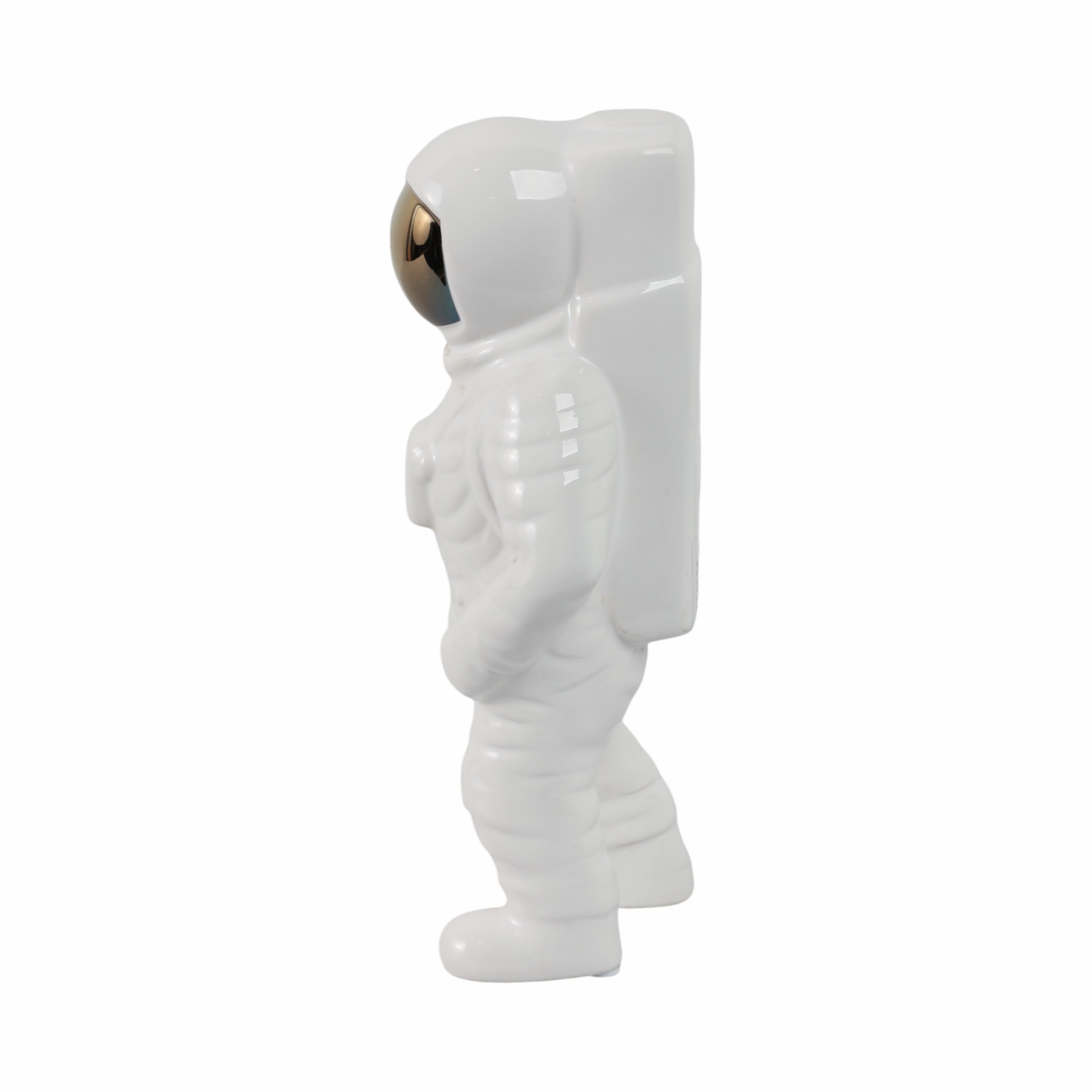 White astronaut figurine on a white background