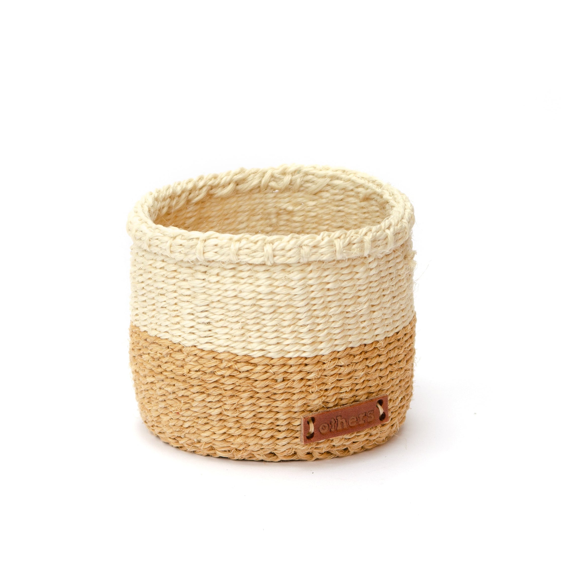 Woven basket with two-tone design on a white background