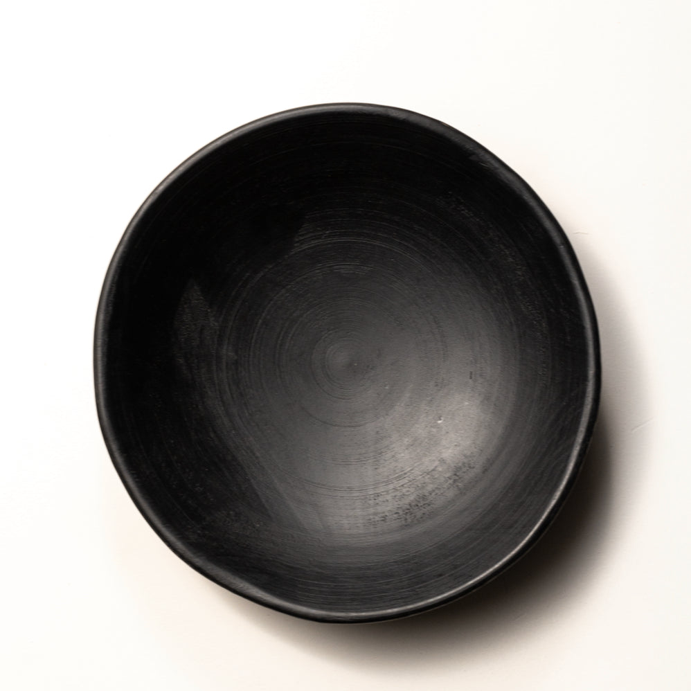 Black ceramic bowl on a white background