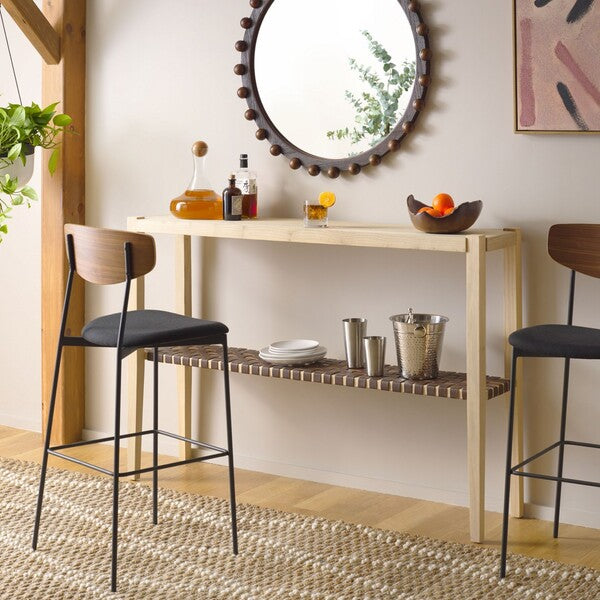 Modern bar area with a wooden counter, stools, and decorative items.