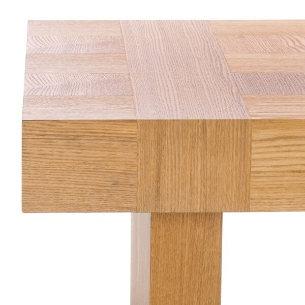 Close-up of a wooden coffee table with a checkered pattern on the surface.