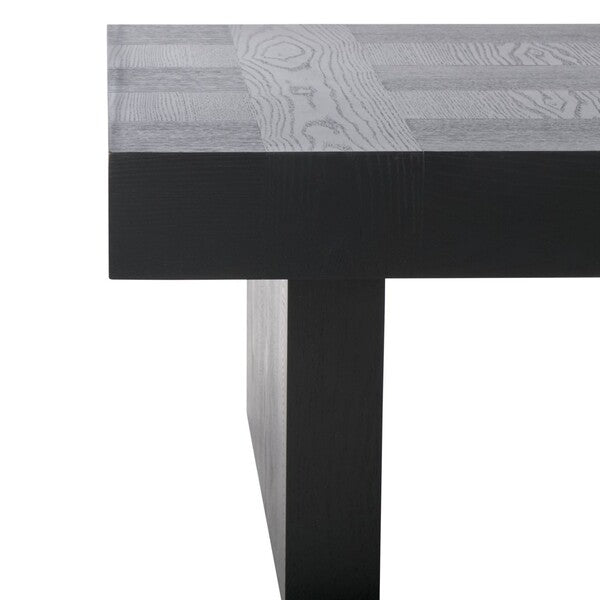Close-up of a table with a black base and gray patterned top.