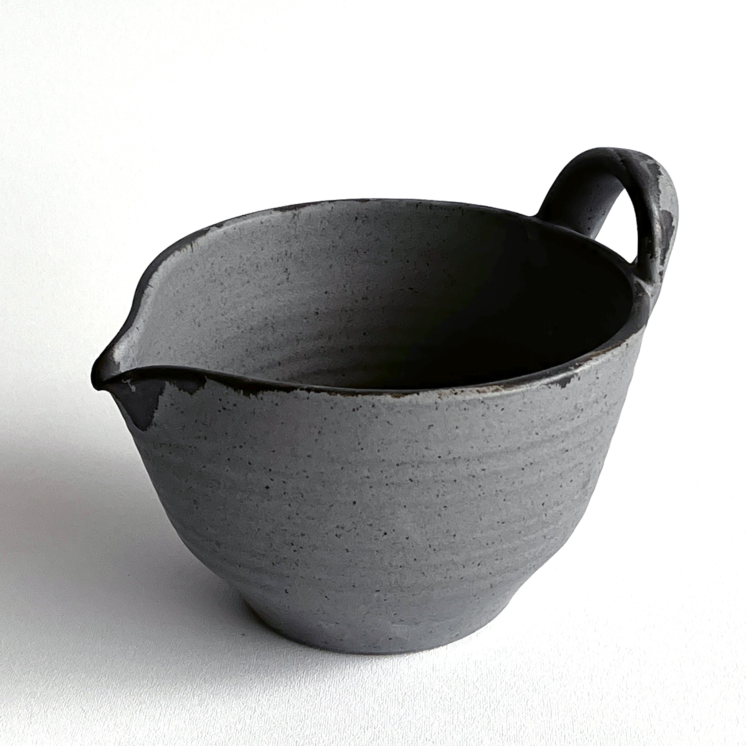 Gray ceramic pitcher on a white background