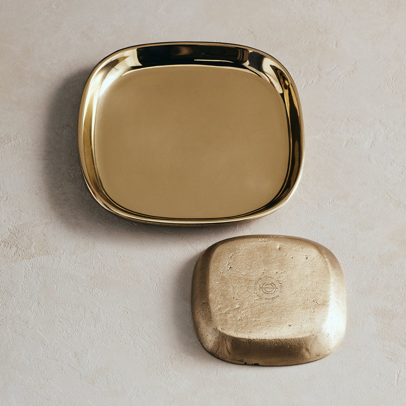 Gold square tray on a beige background