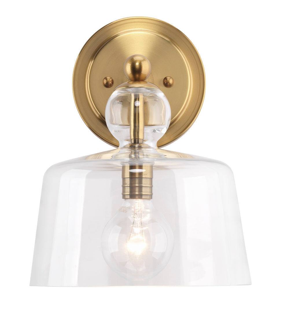 Wall-mounted light fixture with clear glass shade and gold metal finish on a white background