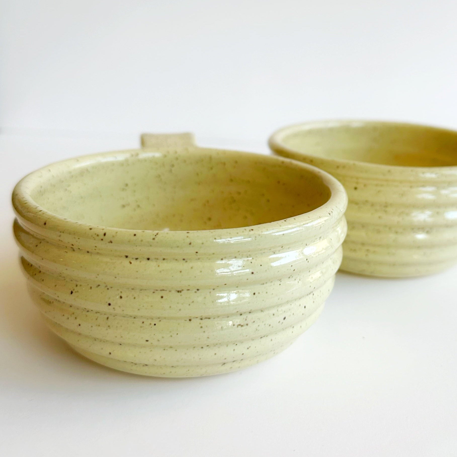 Two ceramic bowls with a textured surface on a white background