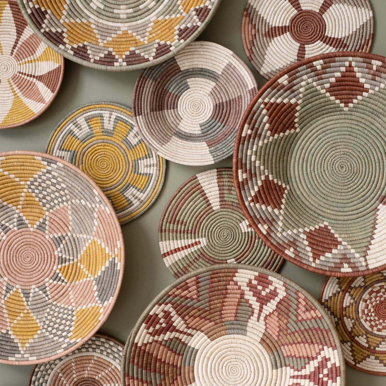 Collection of woven baskets with various patterns on a neutral background