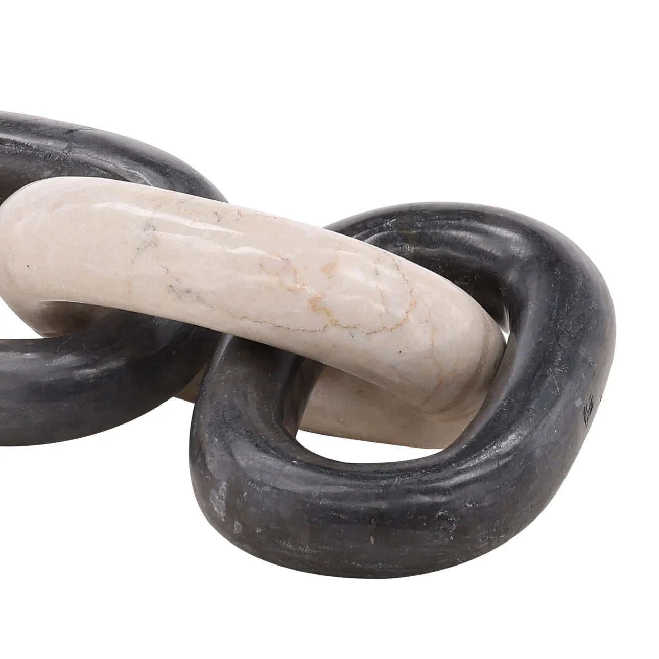 Decorative stone sculpture of interlocking rings on a white background
