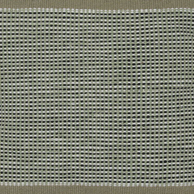 Close-up of a textured fabric with a grid pattern in shades of green and gray.