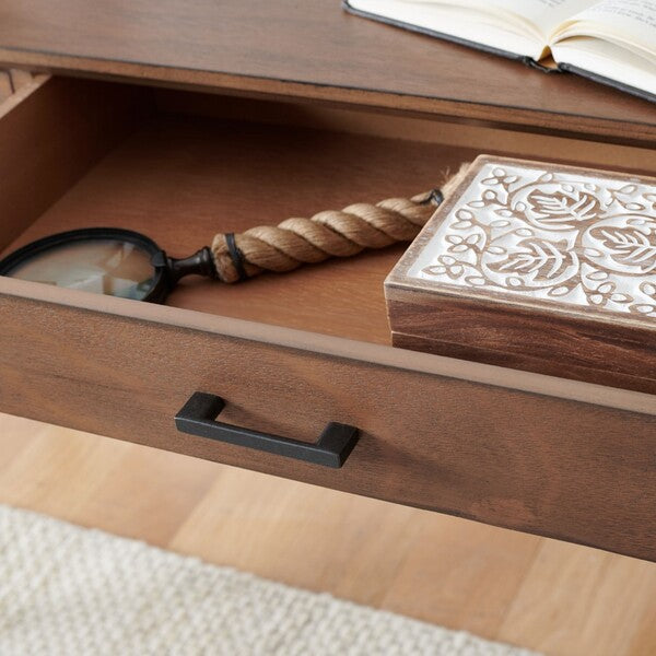 Wooden drawer with decorative box and magnifying glass on a wooden surface.