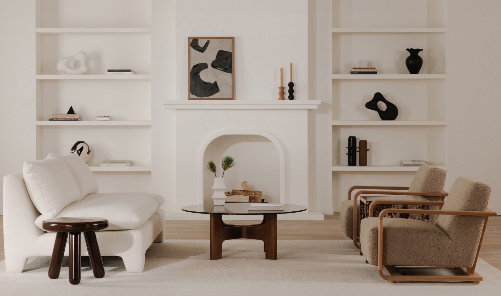 Modern living room with white walls, wooden furniture, and decorative items.
