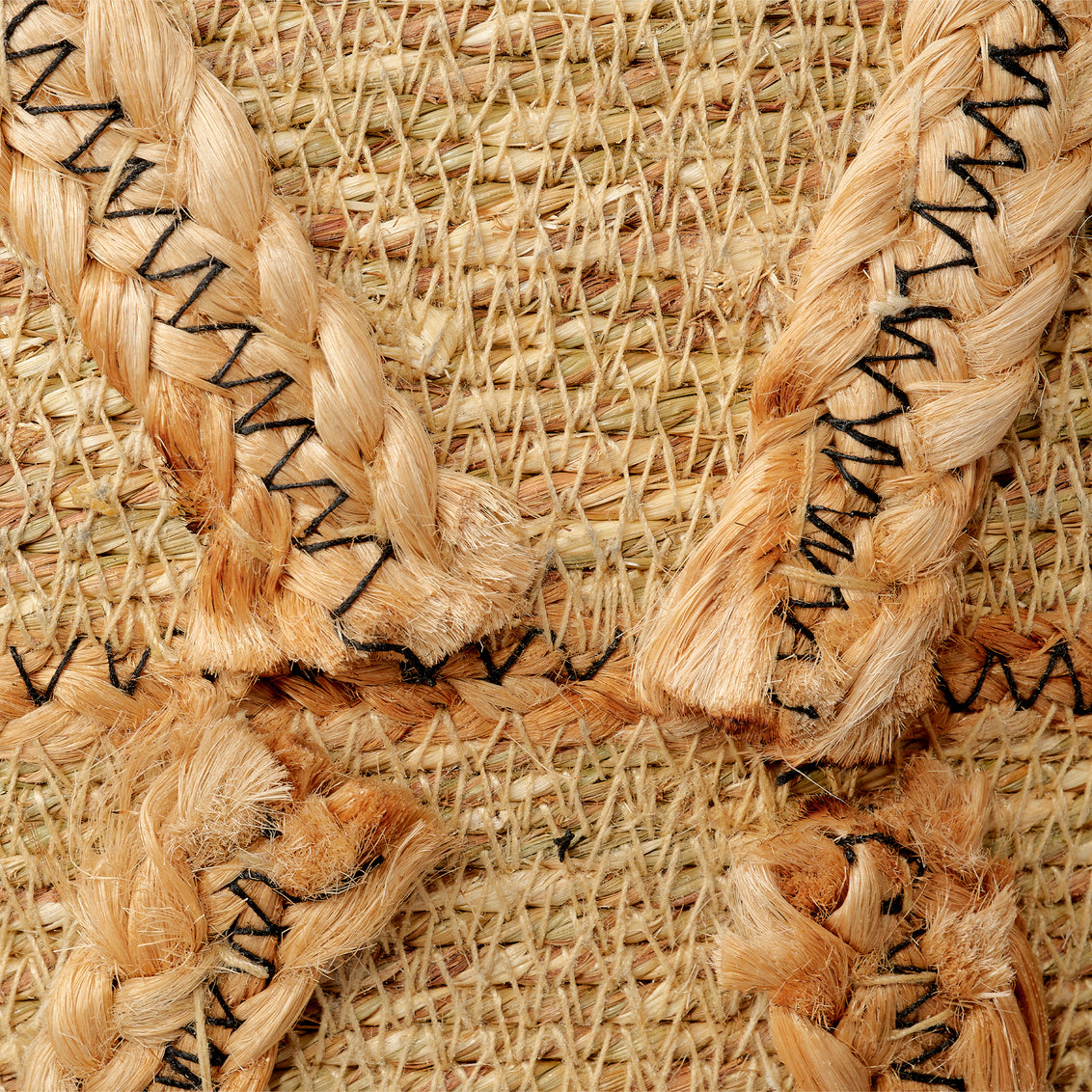 Close-up of woven basket with braided edges and black text on a textured background