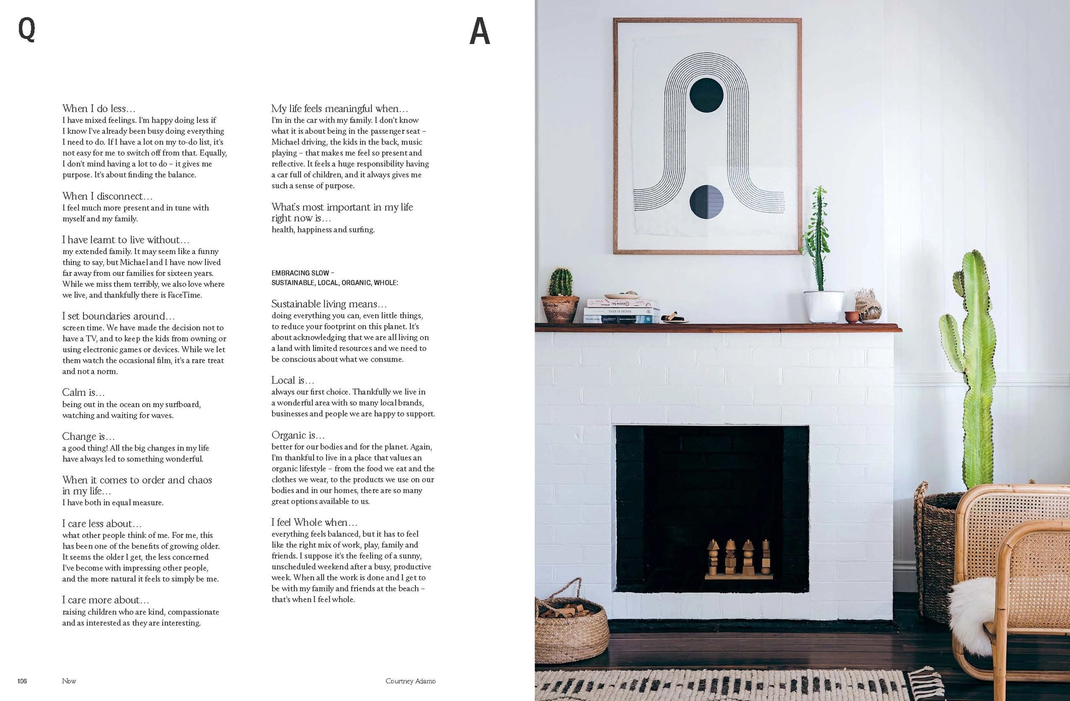 Living room with white fireplace, abstract art, and decor elements.