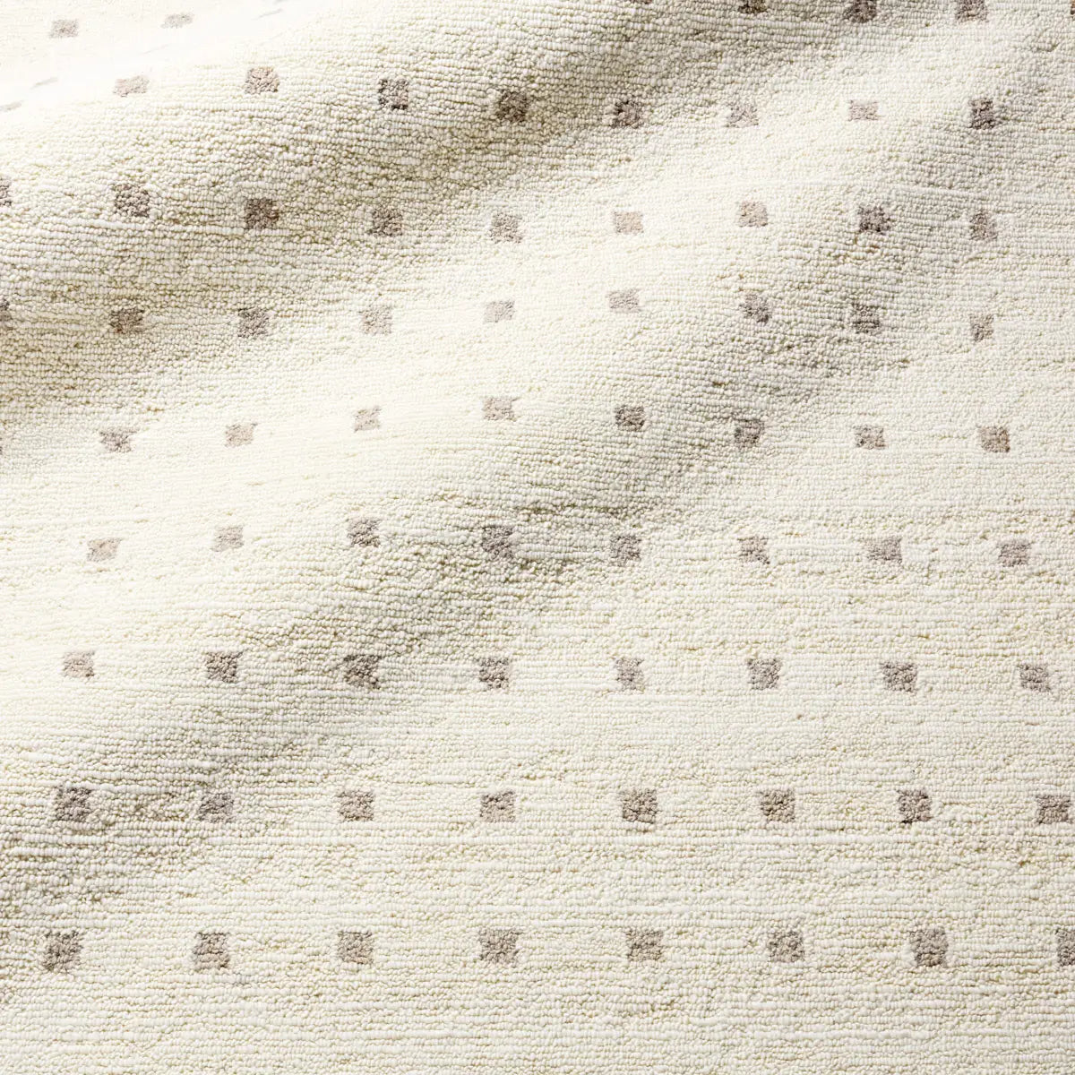 Textured beige fabric with a subtle pattern