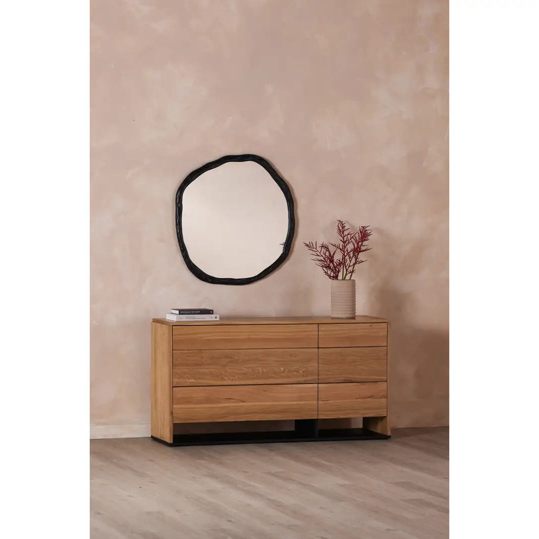 Round mirror with a black frame on a white background