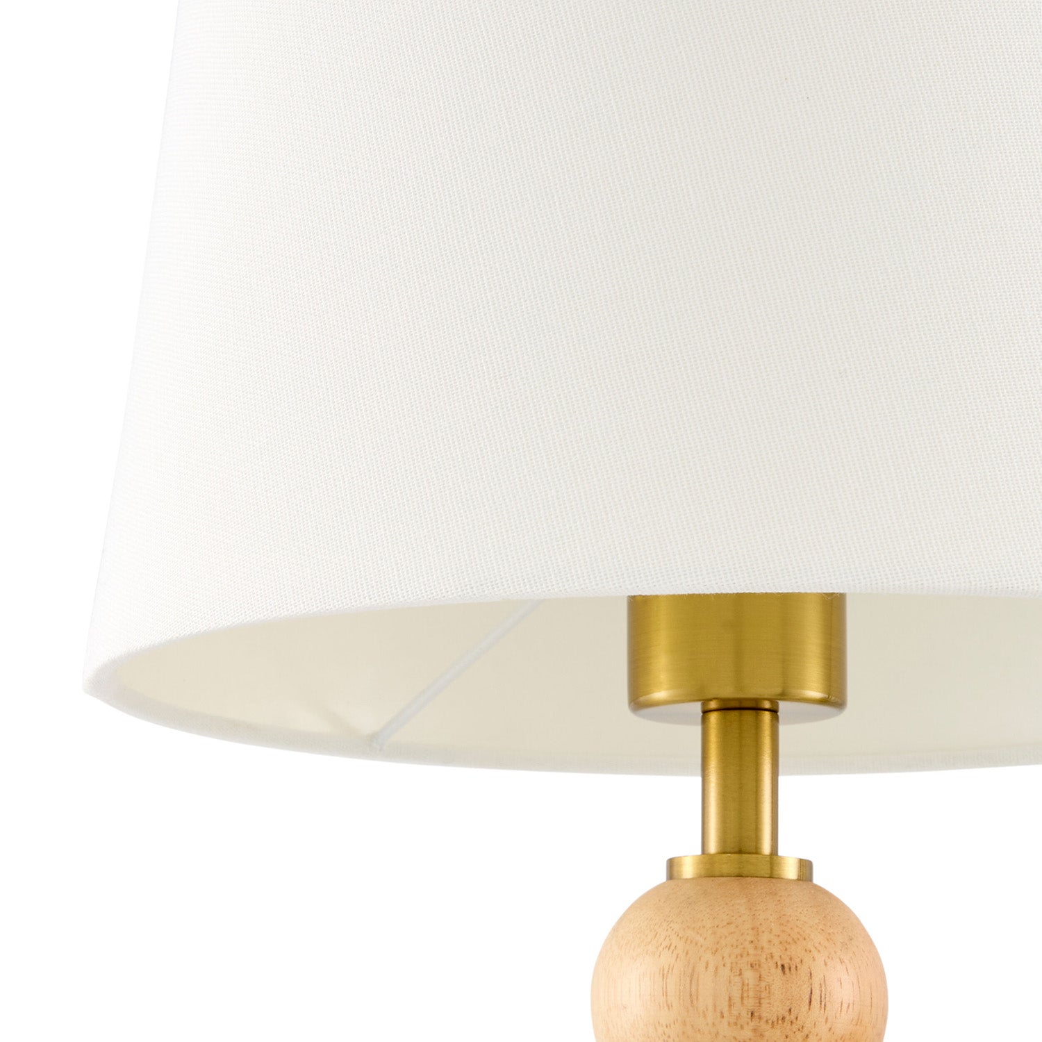 Wall lamp with wooden base and brass fixture on a white background