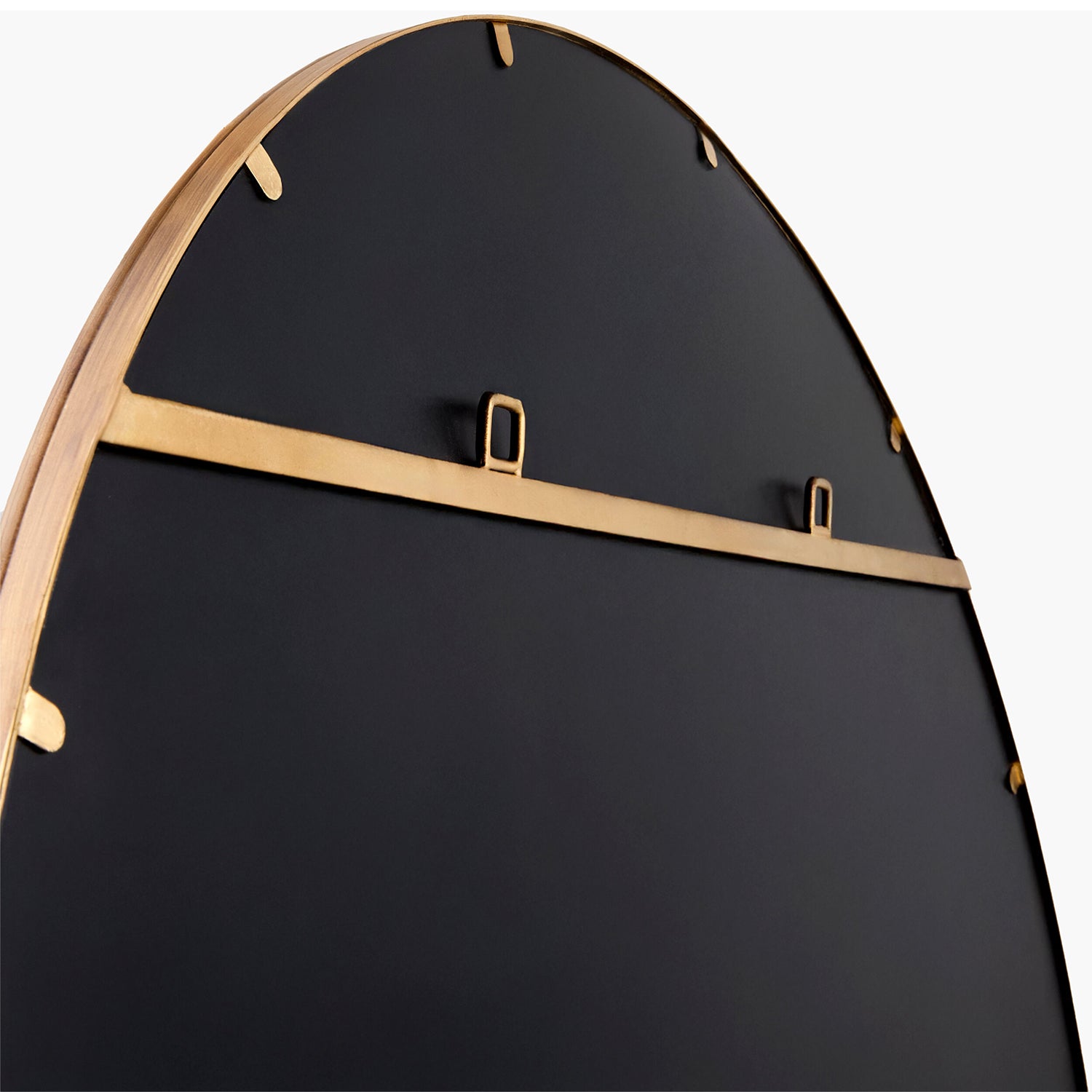 Black mirror backing with gold hardware on a white background