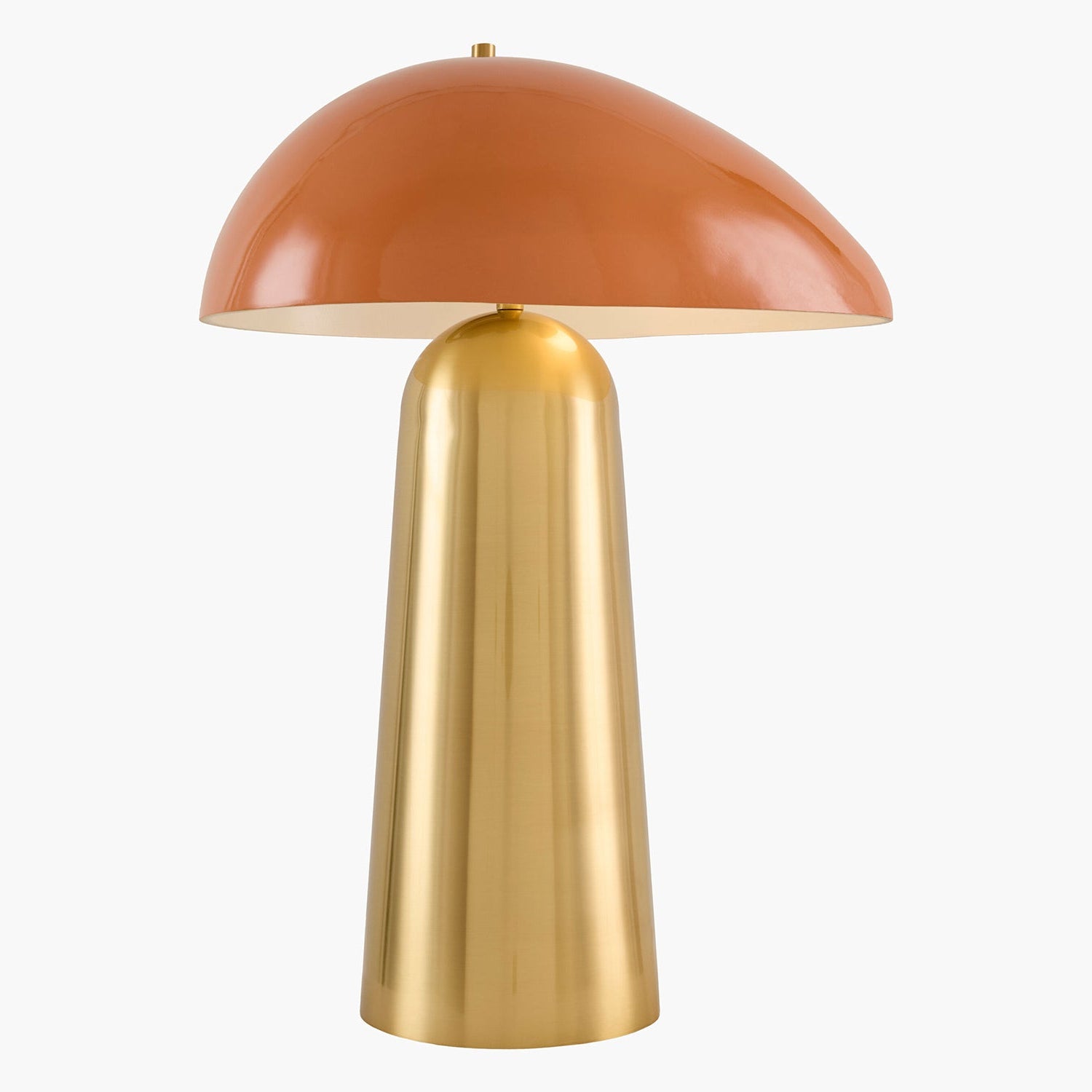 Table lamp with a terracotta-colored shade and gold base on a white background