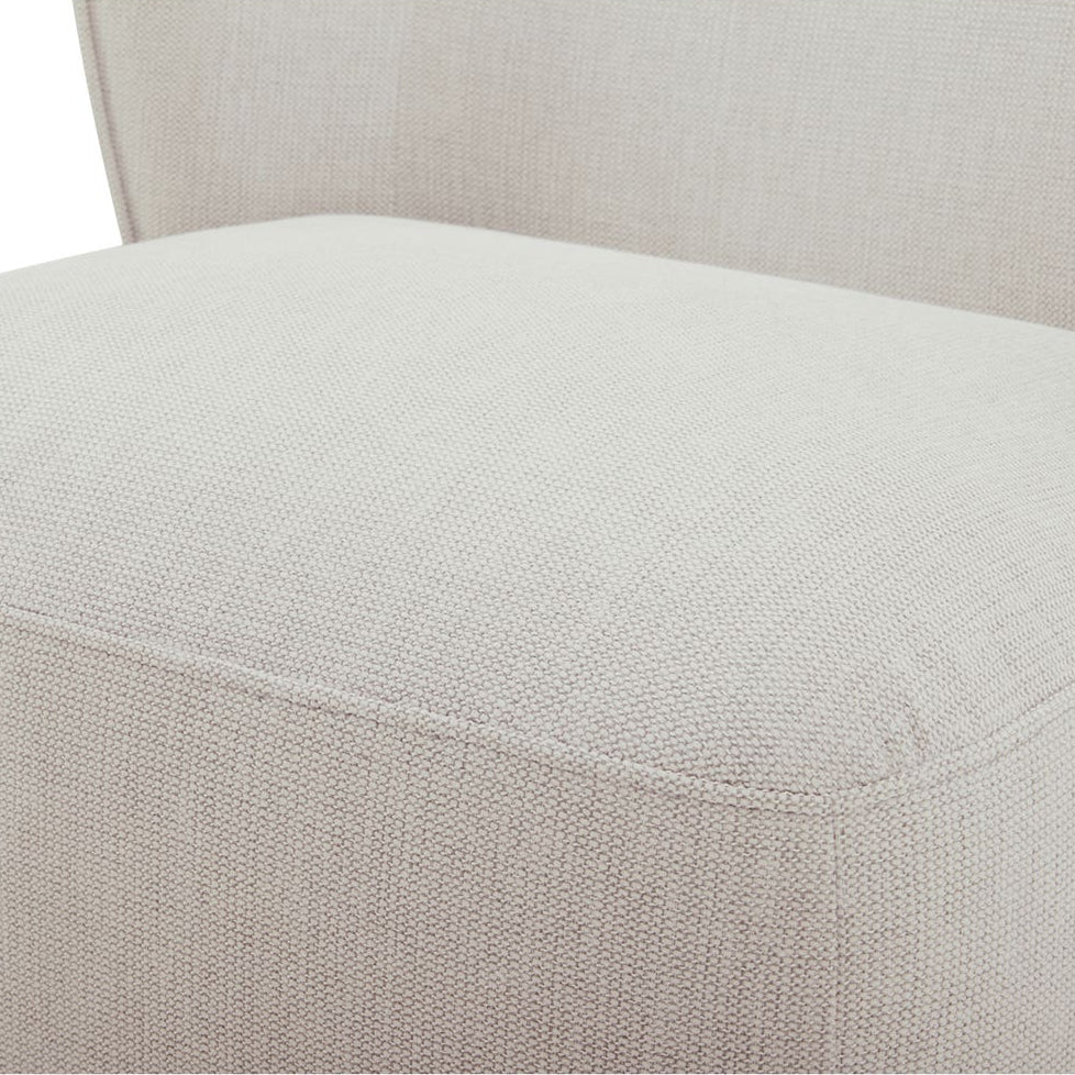 Close-up of a beige upholstered chair seat on a white background