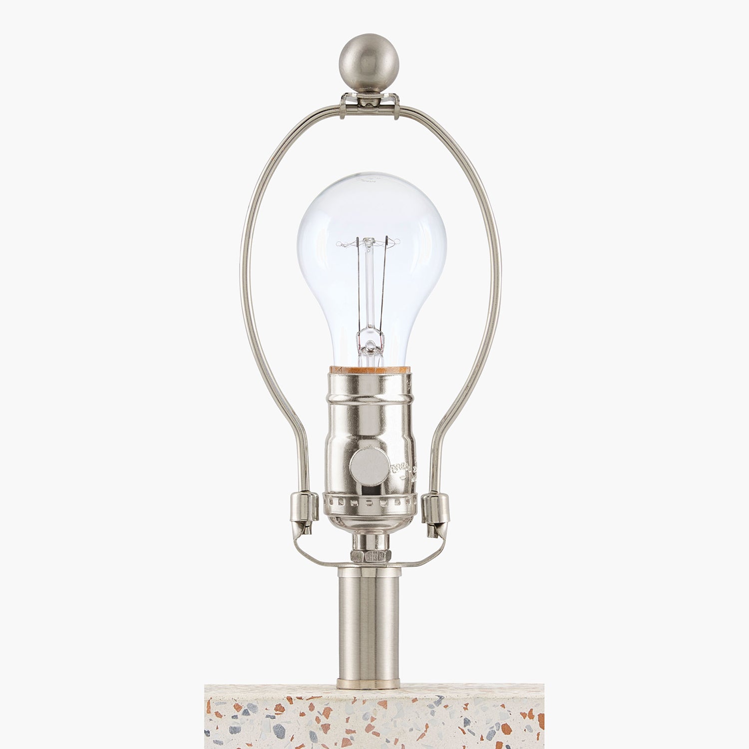 Table lamp with a clear glass shade and metallic base on a white background
