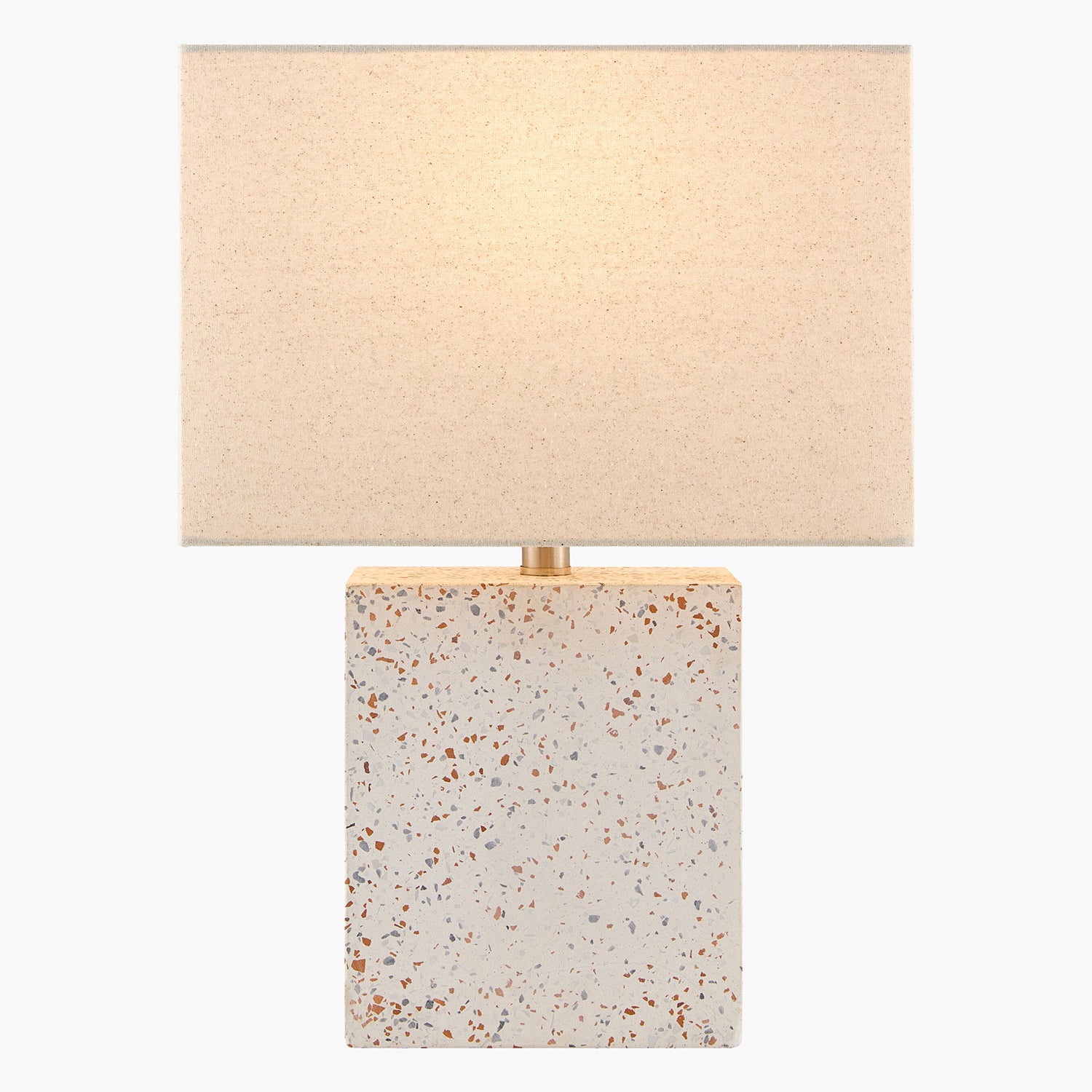 Table lamp with terrazzo base and beige fabric shade on a white background